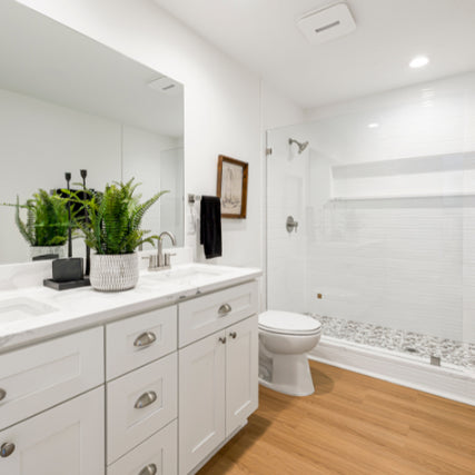 Plumbing SuppliesA bathroom with double sink, toilet and stand up shower