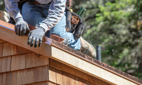 A contractor on a roof installing flashing